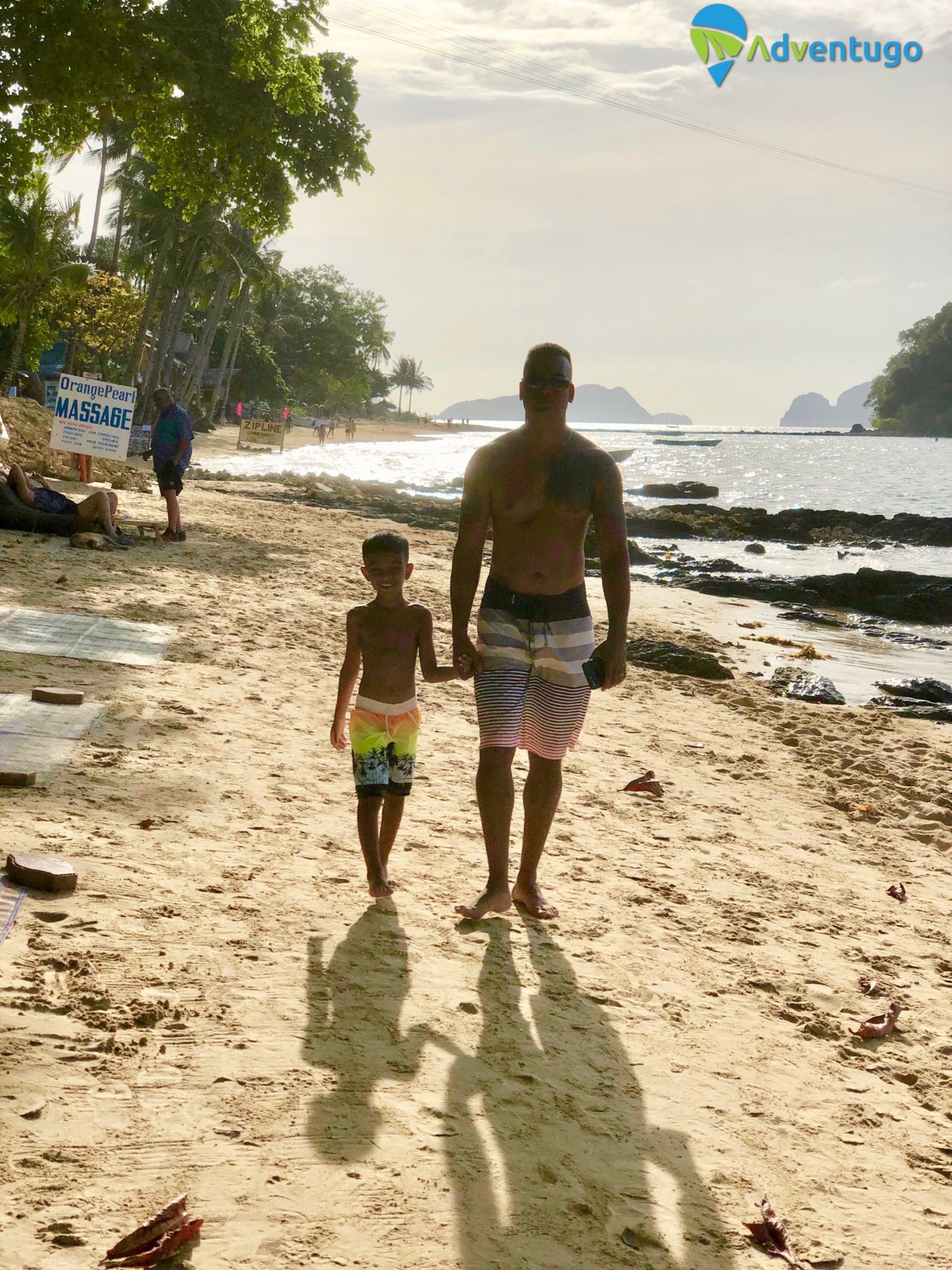 Father and son on Las Cabans Beach, El Nido